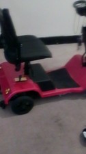 Red 4-Wheeled Mobility Scooter with Basket and Padded Armrest