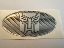 AUTOBOT TRANSFORMERS CAR DOMED GRILL BADGE CARBON SUBAR NEWAGE SIZE 100 X 50MM