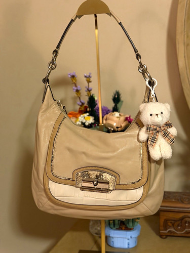 Coach Kristin Spectator leather hobo bag featuring a cream smooth leather body a