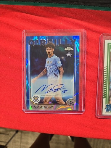 2024-25 Topps Merlin Nico O’Reilly RC Auto Blue 74 /150 Man City AU-NOR Rookie