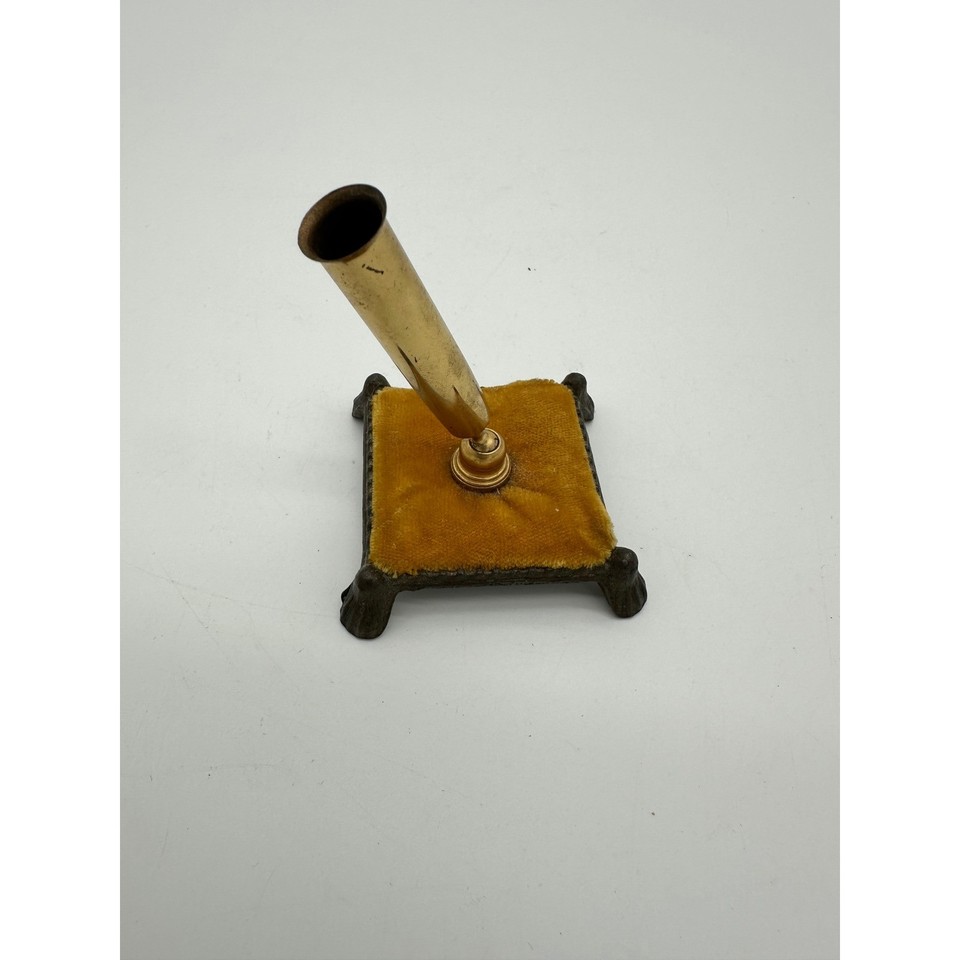 Victorian-style gold-tone pen holder with a velvet cushion cradle — tiny, ornate, and utterly charming on a styled desk.