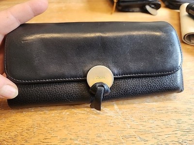 Chloé Indy Long Flap Wallet in black leather featuring distinct  gold Medallion