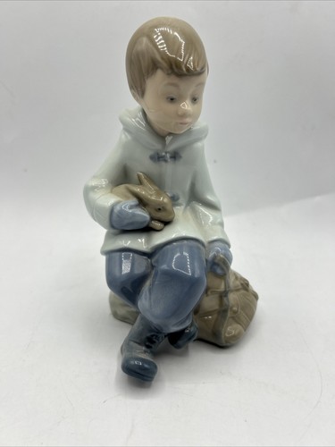 NAO BY LLADRO 'BOY RESTING ON EXCURSION' BOY WITH RABBIT FIGURINE