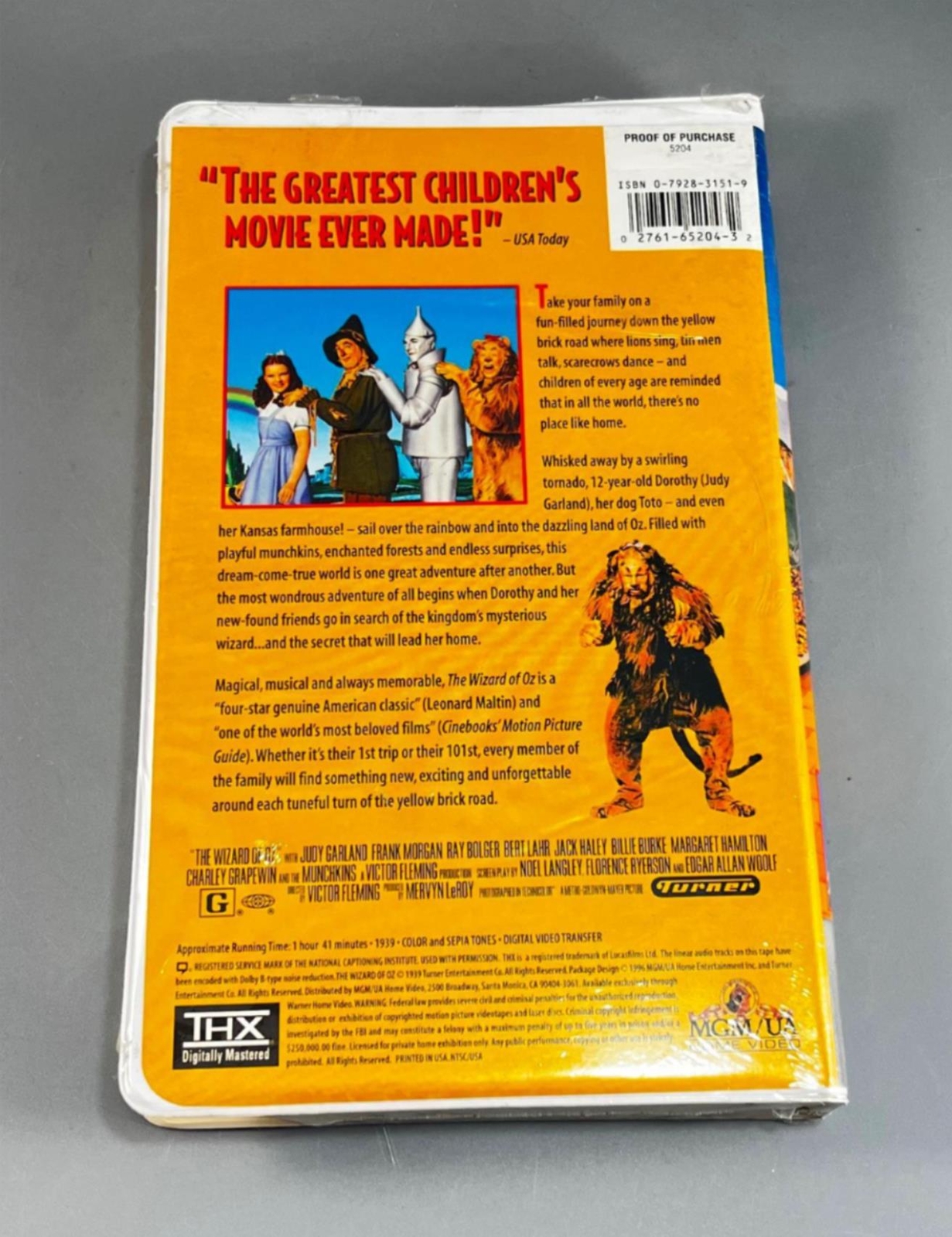 MGM The Wizard Of Oz 1996 VHS cover with ruby slippers, flying monkey, lion, and Wizard Of Oz characters.