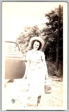Vtg B&W Snapshot Smiling Woman In Sun Hat & Dress Holding Jugs By Old Car 1938
