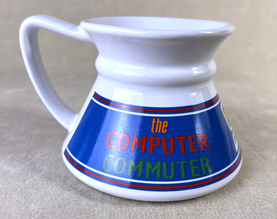 A wide-base no-spill ceramic travel mug plastered with vintage computer graphics — retro tech kitsch that's actually functional.