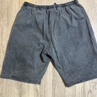 Gray vintage Reebok Riptop Shorts men XL with faded thighs, elastic waistband, and visible stitching on a wooden floor.