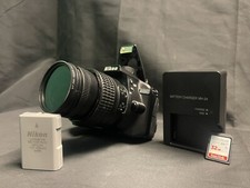 A Nikon Digital Camera A Battery A Charger An SD Card Everything