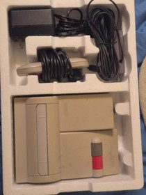 Classic NES game console. 2 controllers and NES advantage in box with packaging