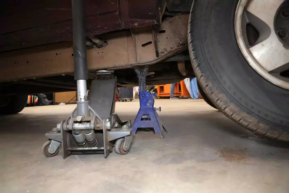 A vehicle lifted up on a jack.