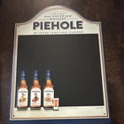 vintage-style Piehole Whiskey tin chalkboard sign advertising three flavors