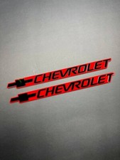 2pcs Black Chevrolet Emblem Badges On Red Background Aggressive 3d Styling