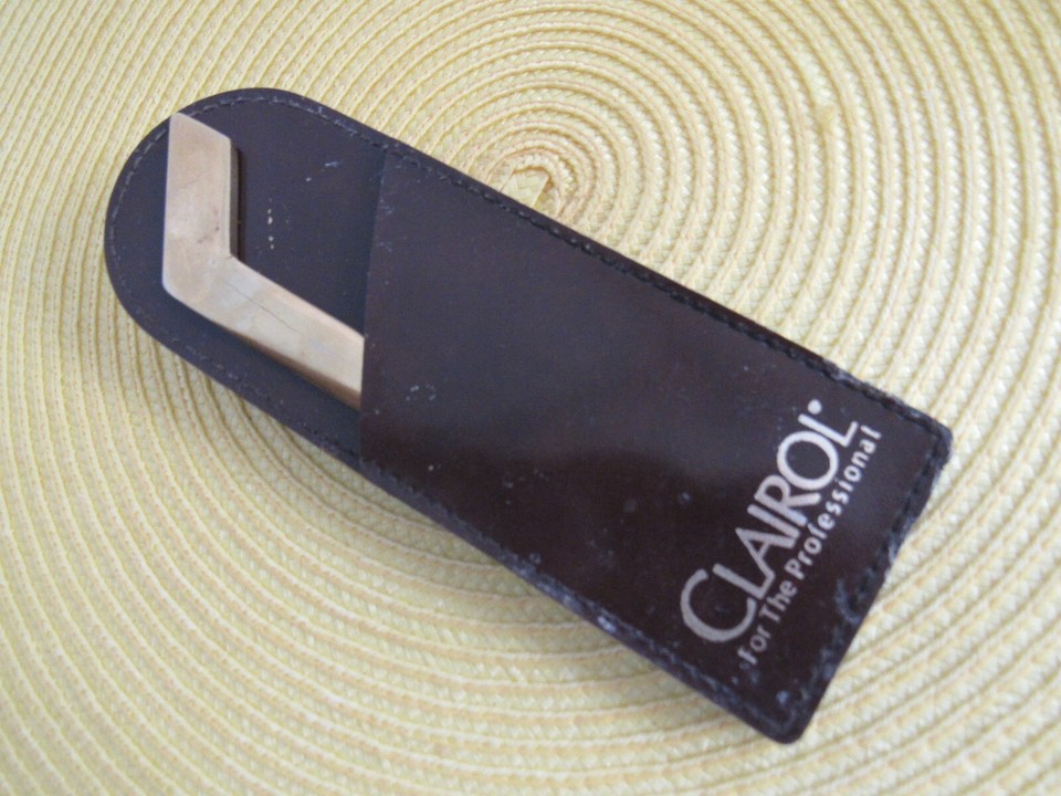 Mid-century Clairol-branded letter opener with original leather sheath, made in Italy — a tiny piece of forgotten brand history that sparks instant curiosity.