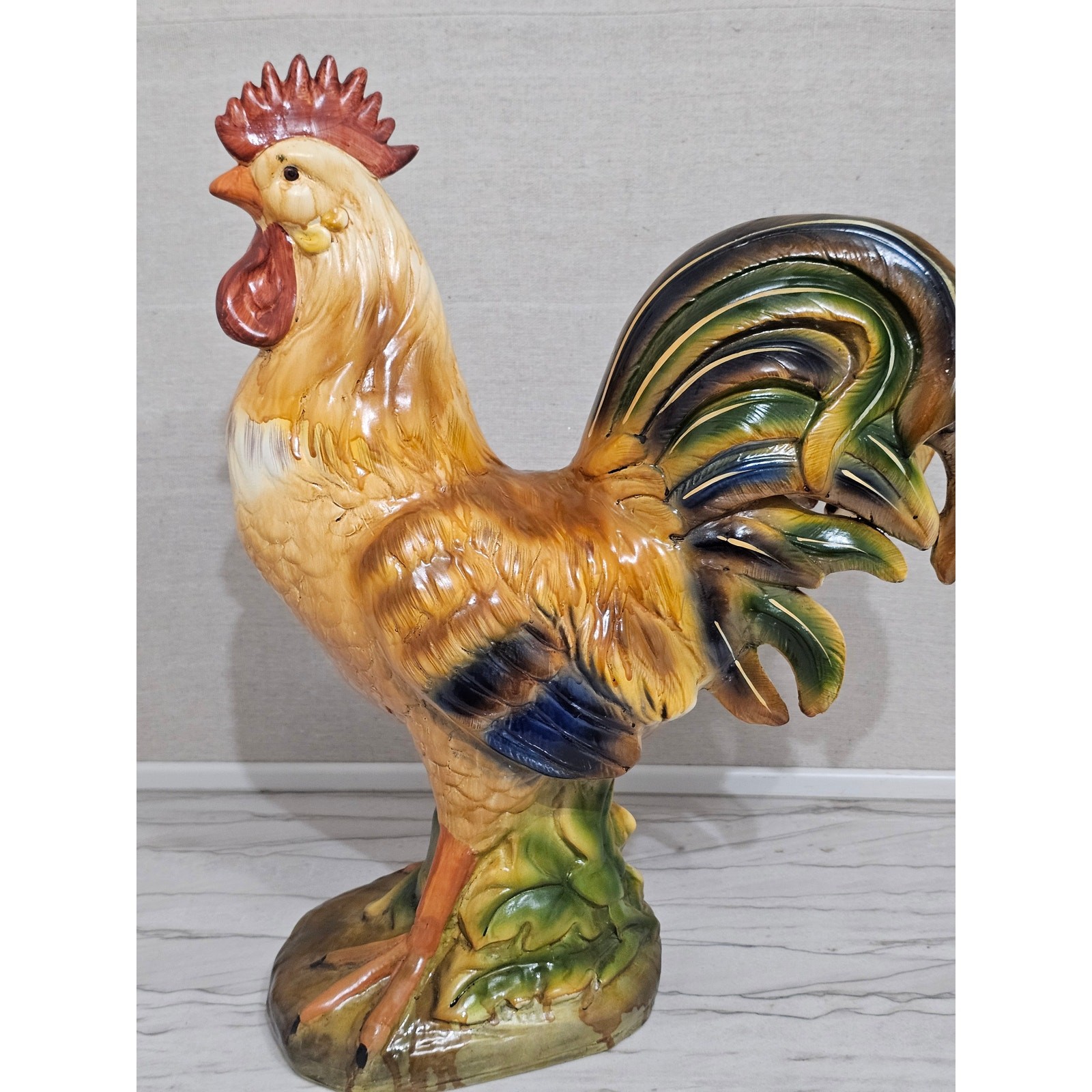 Large hand-painted ceramic rooster figurine in warm tones.
