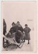 Winter Joyride: Friends Laughing Together on Snowy Sleigh Adventure in the Past
