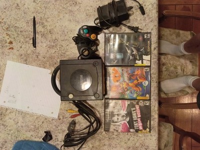 Used black Nintendo GameCube 5x5 with 3 games in medium condition works great