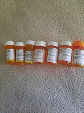 Low angle view of empty pill bottles stock 7 pcs