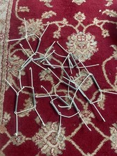 White, spring plate hooks to display plates on the wall, great for antiques. 