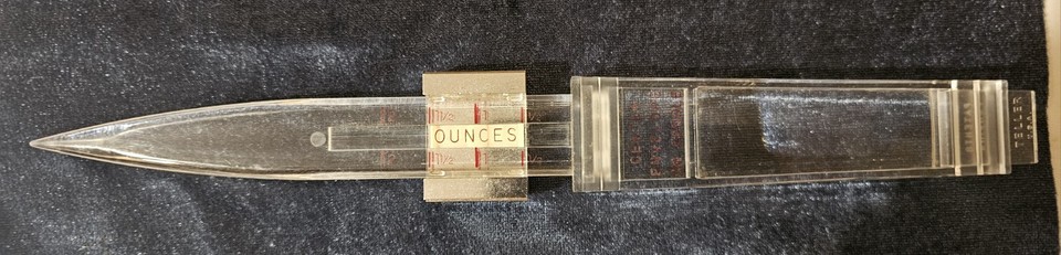 A vintage US combo desk gadget that's simultaneously a postage scale, letter opener, and paper knife — the trifecta of analog office utility.