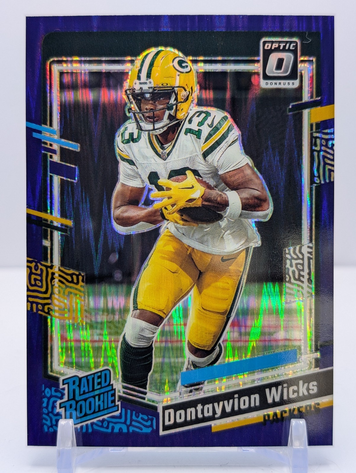 2023 Donruss Optic - Rated Rookie Dontayvion Wicks #249 Purple Shock Prizm (RC)