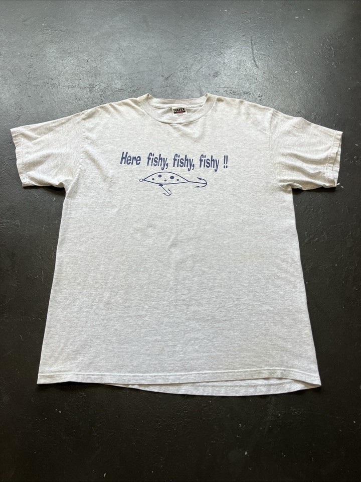 A genuinely faded, worn-in 90s fishing humor tee — the kind of authentically aged graphic shirt that vintage hunters actually dig through bins to find.