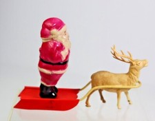 Vintage Celluloid Santa Claus on Sled with One Reindeer Christmas Decoration