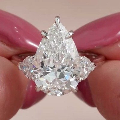 4.29Ctw Pear Cut Moissanite Three Stone Engagement Ring In 14K White Gold Plated