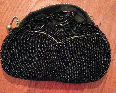 Vintage beaded clutch purse with a decorative V-pattern.
