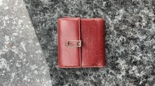 burgundy Coach vintage trifold envelope wallet With a distinct buckle closure