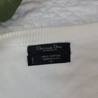 White VTG Christian Dior men’s V-neck sweater with black fabric tag and white “Christian Dior Moiseur” text.