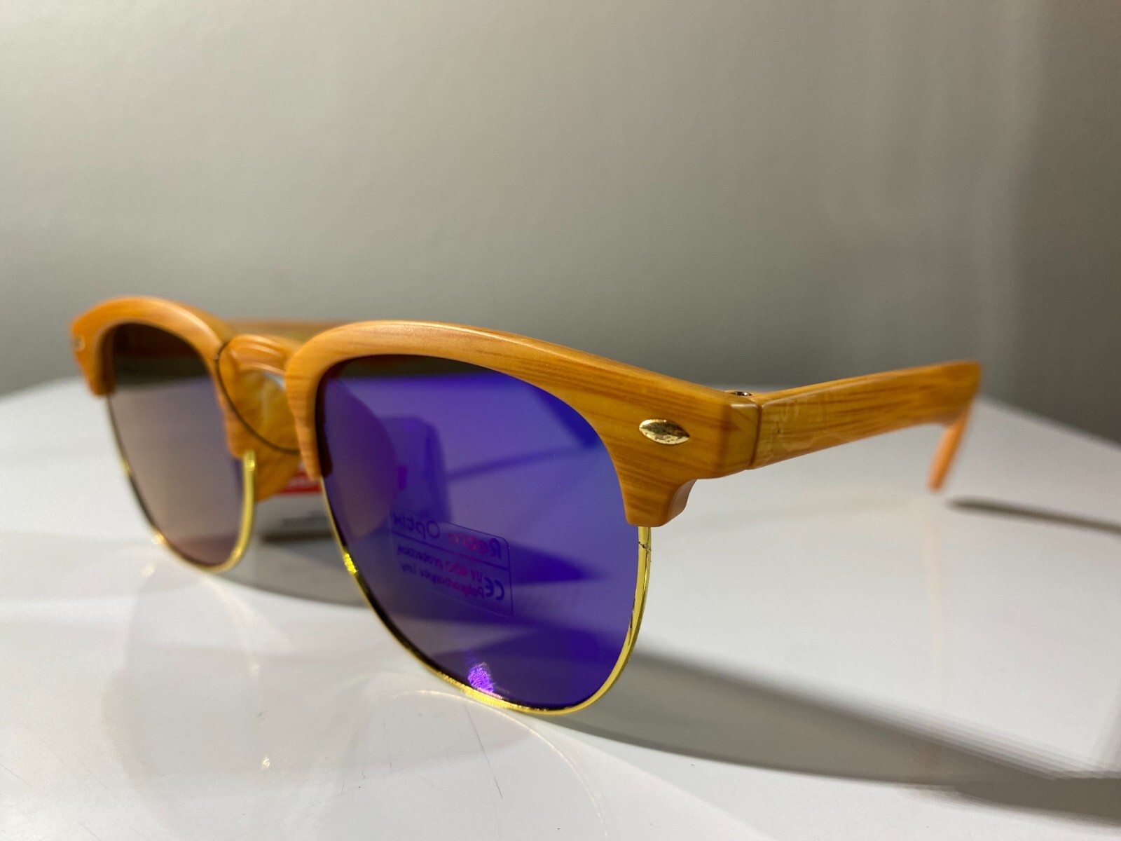 Classic 60's style sunglasses with wood like frame and purple reflective lenses