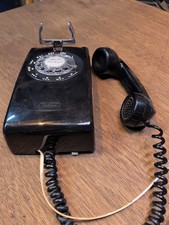 vintage black Western Electric Model 554 rotary wall telephone.