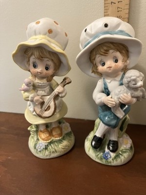 Two Figurines Of A Girl Playing A Mandolin And A Girl Holding A Lamb.