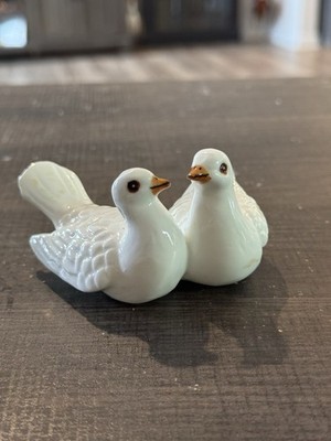 Glossy white ceramic dove figurines with painted details