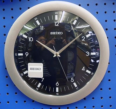 SEIKO ROUND WALL CLOCK 12'' IN DIAMETER  SILVER SURROUND AND BLACK DIAL QXA137KLH