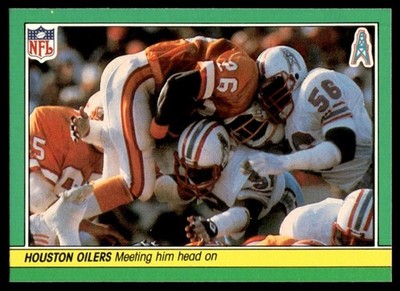 1984 FLEER TEAM ACTION MEETING HIM HEAD ON (DEFENSE) C HOUSTON OILERS #22