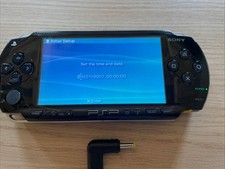 Sony PSP-1003 Black – Good Condition - powers on - No battery/ battery cover inc
