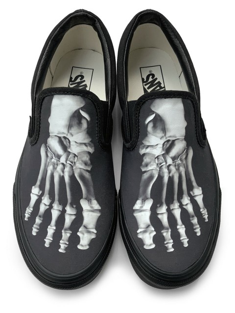 vans skeleton slip ons