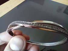 12 gramme solid silver and Cubic Zirconia bangle with hinge opening mechanism.