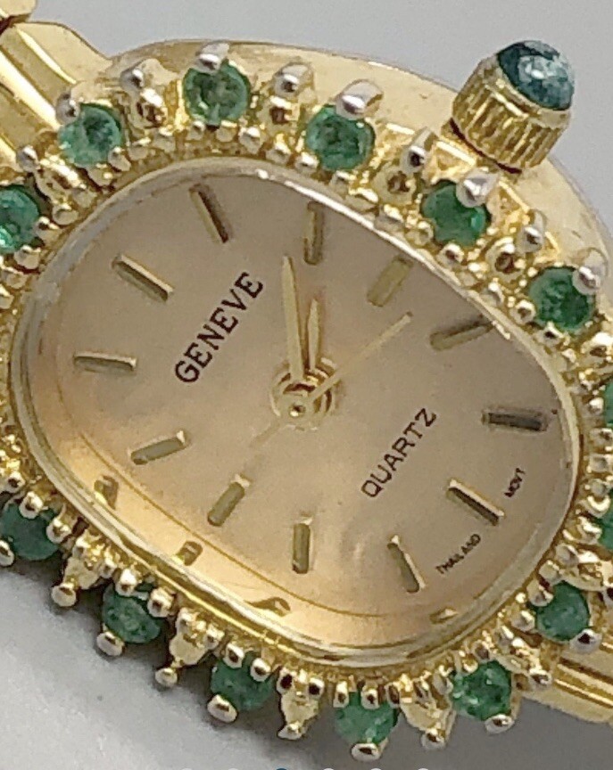 Gold tone metal Geneve womens Wristwatch features an emerald  display picture 3