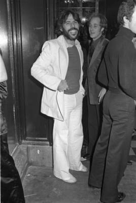 Artist Peter Max wearing a white suit at the Grand Ballroom opening Old Photo