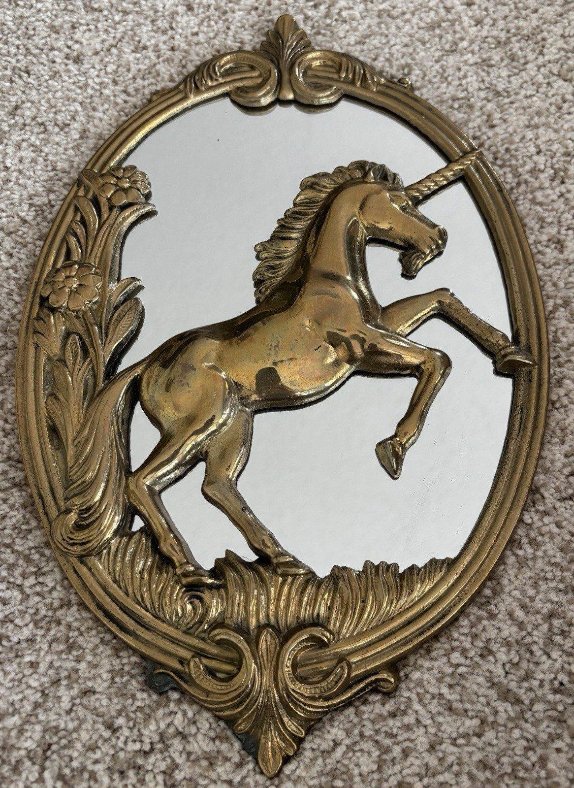 Ornate solid brass wall mirror shaped like a unicorn.