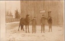 RPPC Two Boys With Horses Barn Farm Snow real photo Postcard JA19