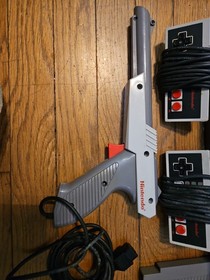 Nintendo NES Console Lot with 2 Controllers, 1 Zapper, 7 Games, and Cords