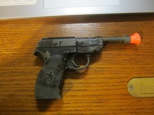 Cast metal toy. Cap gun.