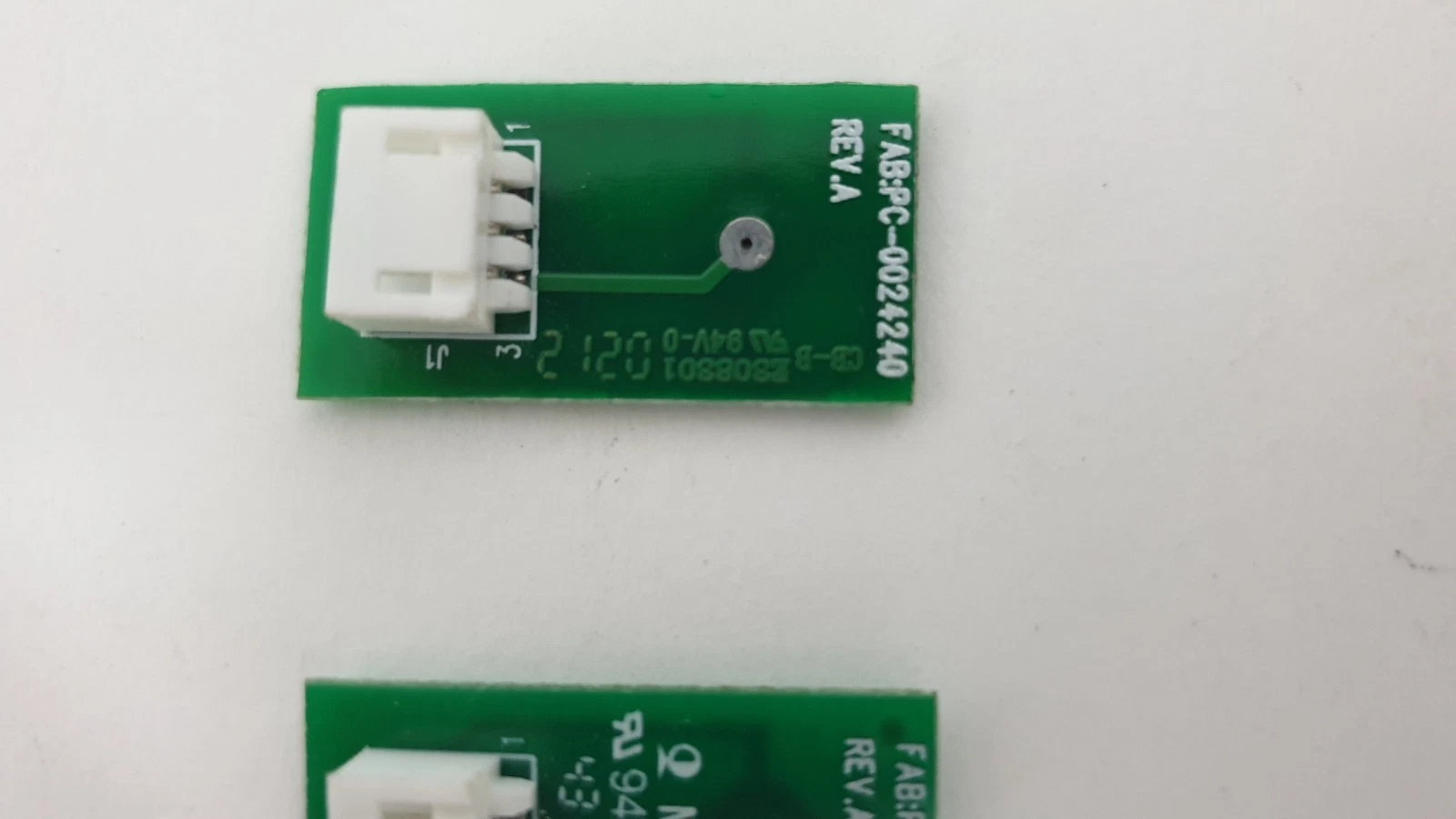 Close-up of PC-0024240 Rev A board back with 3-pin connector J1