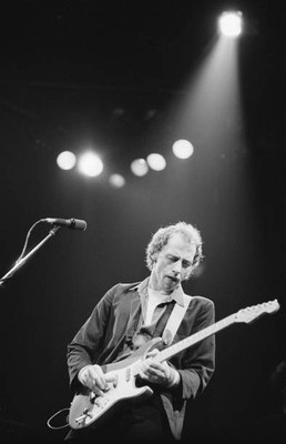 Mark Knopfler guitarist with Dire Straits playing the guitar on st- Old Photo