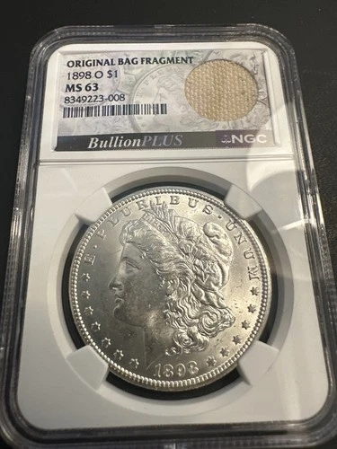 1898-O Morgan Silver Dollar MS63 NGC w/ Mint Bag Fragment 🔥 Unique Holder
