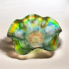 Green carnival glass ruffled bowl with 'Stippled Rays' pattern by Fenton