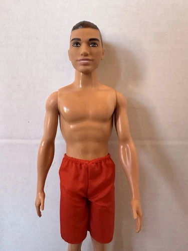 Ken Doll With Heavy Build And With A Man Bun In Swim Shorts